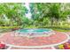 Picturesque water fountain in a landscaped garden setting with benches at 14705 Canopy Dr, Tampa, FL 33626