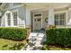 Charming entrance with brick accents, white trim, and meticulously maintained landscaping at 14705 Canopy Dr, Tampa, FL 33626