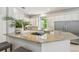 A gourmet kitchen features granite counters, stainless steel appliances, gas cooktop and white cabinetry at 14705 Canopy Dr, Tampa, FL 33626