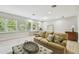Cozy living room with natural lighting, wood floors, and neutral wall paint at 14705 Canopy Dr, Tampa, FL 33626