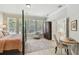 Serene main bedroom featuring large windows, hardwood floors, and a calm, inviting atmosphere at 14705 Canopy Dr, Tampa, FL 33626