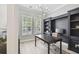 Bright home office with custom built-ins, sleek desk, and stylish modern lighting at 14705 Canopy Dr, Tampa, FL 33626