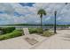 Relaxing poolside lounge area with lake view and lush landscaping at 14705 Canopy Dr, Tampa, FL 33626