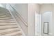Bright stairway with natural wood treads and white risers, leading to a landing at 14705 Canopy Dr, Tampa, FL 33626