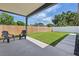 A covered patio with backyard view and two Adirondack chairs offer an ideal outdoor living space at 1514 55Th N Ave, St Petersburg, FL 33703