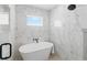 Modern bathroom featuring soaking tub, marble accents, sleek fixtures, and lots of natural light at 1514 55Th N Ave, St Petersburg, FL 33703