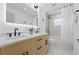 Contemporary bathroom featuring dual sinks, modern fixtures, walk-in shower, and neutral color palette at 1514 55Th N Ave, St Petersburg, FL 33703