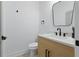 Modern half bathroom features sleek black fixtures, a stylish mirror, and a light wood vanity at 1514 55Th N Ave, St Petersburg, FL 33703
