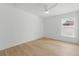 Neutral bedroom features hardwood floors, ceiling fan, natural light, and minimalist design at 1514 55Th N Ave, St Petersburg, FL 33703