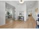 Bright foyer featuring hardwood floors and modern decor, leading to the home office and dining area at 1514 55Th N Ave, St Petersburg, FL 33703