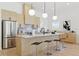 Bright kitchen features stainless steel appliances, a marble backsplash, an island, and modern pendant lighting at 1514 55Th N Ave, St Petersburg, FL 33703