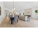 Open-concept living space with fireplace, modern lighting, and seamless flow to dining and kitchen areas at 1514 55Th N Ave, St Petersburg, FL 33703