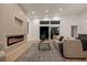 Relaxing living room featuring sleek fireplace, modern decor, neutral color palette, and sliding glass door at 1514 55Th N Ave, St Petersburg, FL 33703