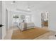 Bright main bedroom boasts tray ceiling, ceiling fan, natural light, and access to the ensuite bathroom at 1514 55Th N Ave, St Petersburg, FL 33703