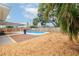 Backyard with a pool, patio area, and mature landscaping at 1758 Southview Rd, Largo, FL 33770
