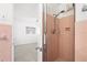 Pink tiled bathroom with open shower and view into bedroom at 1758 Southview Rd, Largo, FL 33770