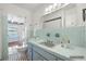 Vintage-style bathroom featuring pastel tile, patterned floor, and a large mirror at 1758 Southview Rd, Largo, FL 33770