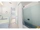 Charming bathroom featuring a blue tiled shower and classic black and white tiled floors at 1758 Southview Rd, Largo, FL 33770