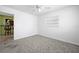Neutral carpet and a window with blinds are features of this room at 1758 Southview Rd, Largo, FL 33770