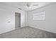 This bedroom has carpet, a window with blinds, a ceiling fan, and a closet at 1758 Southview Rd, Largo, FL 33770
