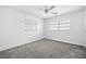 Bright bedroom with two windows, plush carpet and a ceiling fan provides comfort at 1758 Southview Rd, Largo, FL 33770