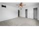 Well-lit bedroom featuring neutral carpet, a ceiling fan, and a spacious closet at 1758 Southview Rd, Largo, FL 33770