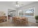 Bright dining room features a wood table set and large windows overlooking the pool at 1758 Southview Rd, Largo, FL 33770