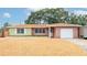 Charming single-story home with a well-maintained lawn, brick accents, and an attached garage at 1758 Southview Rd, Largo, FL 33770