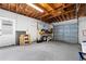 Spacious garage with a roll-up door and painted concrete flooring at 1758 Southview Rd, Largo, FL 33770