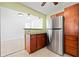 Functional kitchen with stainless steel refrigerator, granite countertops, and abundant cabinetry for easy organization and convenience at 1758 Southview Rd, Largo, FL 33770