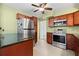 Kitchen with stainless steel appliances, wooden cabinets and stone countertops at 1758 Southview Rd, Largo, FL 33770