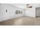 Bright living room featuring a large window, ceiling fan, and ample natural light, creating a welcoming space at 1758 Southview Rd, Largo, FL 33770