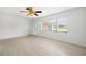 Bright living room featuring wood floors, white walls and a ceiling fan at 1758 Southview Rd, Largo, FL 33770