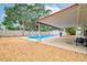 Backyard pool area with a covered patio and mature trees at 1758 Southview Rd, Largo, FL 33770