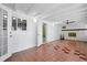 Spacious sun room with tiled floors, whitewashed brick walls, beamed ceilings and doorway to adjacent bathroom at 1758 Southview Rd, Largo, FL 33770