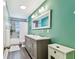 Bright bathroom features a dual sink vanity, tile floors, and modern fixtures at 17605 Simmons Rd, Lutz, FL 33548