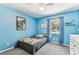 Bright bedroom with blue walls, a ceiling fan, and plenty of natural light at 17605 Simmons Rd, Lutz, FL 33548