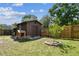 Backyard shed with a small tree and playhouse at 17605 Simmons Rd, Lutz, FL 33548