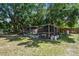 Large grassy backyard with chicken coop and garden at 17605 Simmons Rd, Lutz, FL 33548
