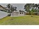 Spacious backyard with lush green lawn, privacy fence, and patio area at 1835 Nevada Ne Ave, St Petersburg, FL 33703