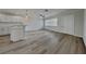 Open-concept living area featuring hardwood floors and modern lighting fixtures at 1835 Nevada Ne Ave, St Petersburg, FL 33703