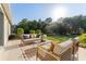 Inviting back patio area with comfortable outdoor seating and view of the landscaped backyard at 20146 Heritage Point Dr, Tampa, FL 33647