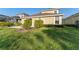 Backyard featuring a small concrete patio and beautiful green grass at 20146 Heritage Point Dr, Tampa, FL 33647