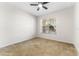 Bright bedroom with neutral carpet, ceiling fan, and a large window at 20146 Heritage Point Dr, Tampa, FL 33647