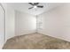 Comfortable bedroom with neutral carpet, fan, and a bright window view at 20146 Heritage Point Dr, Tampa, FL 33647