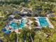 Aerial view featuring resort-style pools surrounded by palm trees, offering a luxurious community experience at 20146 Heritage Point Dr, Tampa, FL 33647