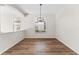 Dining area with wood floors, large window, and a modern chandelier at 20146 Heritage Point Dr, Tampa, FL 33647
