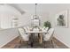 Dining area with marble table set and contemporary lighting, with an open concept living area at 20146 Heritage Point Dr, Tampa, FL 33647