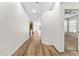 Long hallway featuring modern floors and neutral walls, connecting various living spaces in the home at 20146 Heritage Point Dr, Tampa, FL 33647