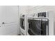 Bright laundry room featuring modern appliances and overhead shelving at 20146 Heritage Point Dr, Tampa, FL 33647